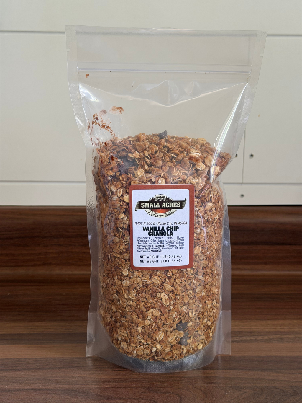 Packaged granola with a label on a wooden surface