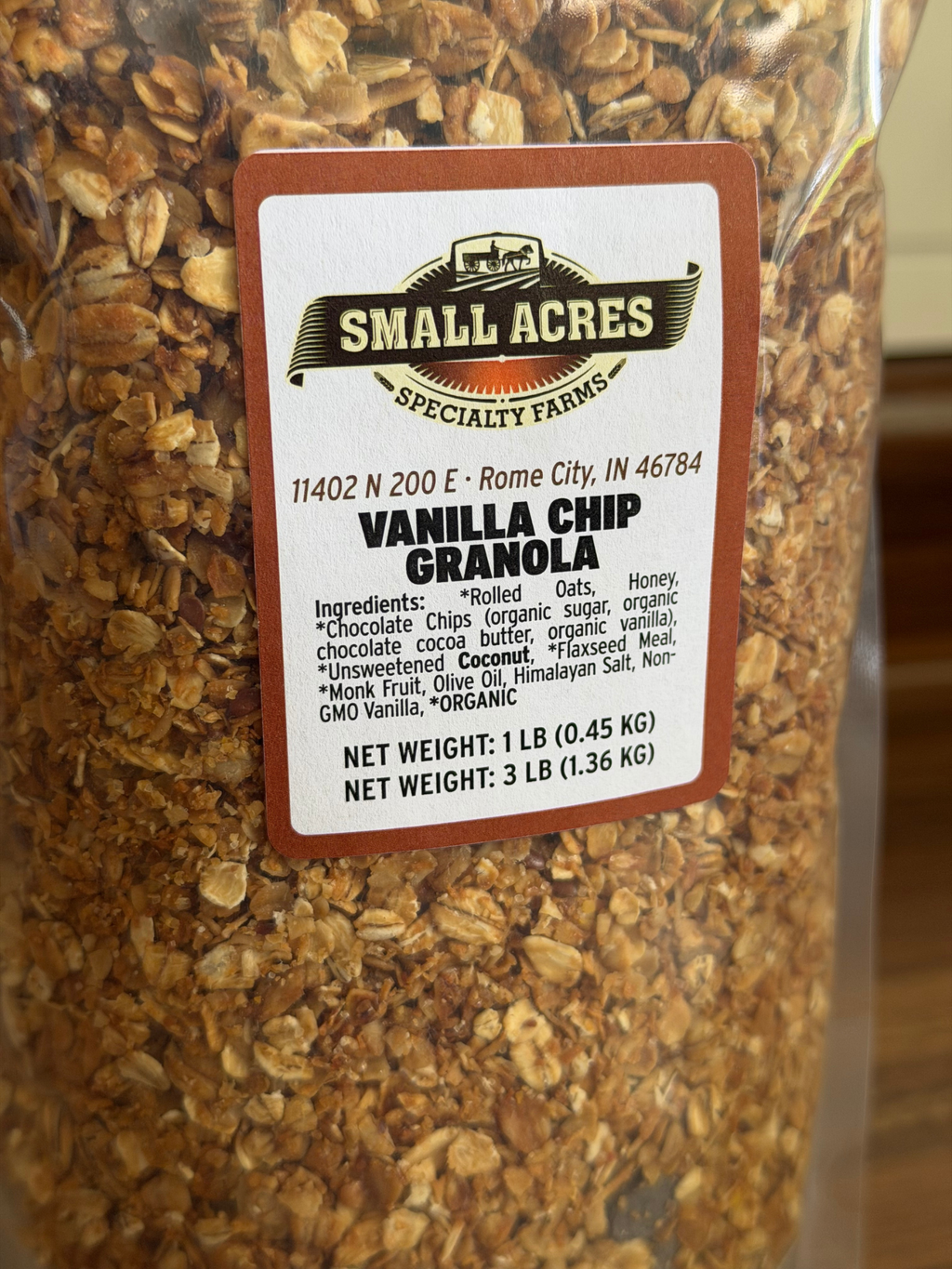 Close up of vanilla chip granola with a label on a wooden surface