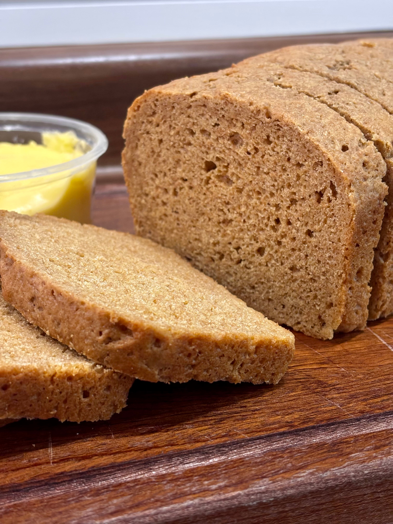 close up of einkorn bread on a wooden cutting board
